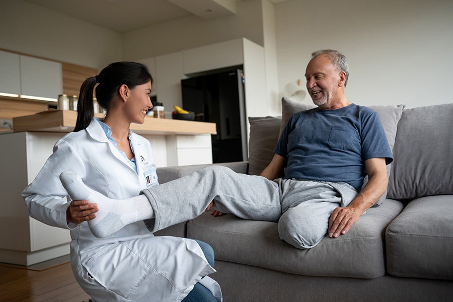 Health worker working with leg amputee