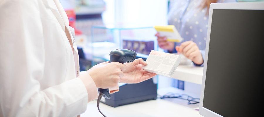 woman scanning drug at pharmacy