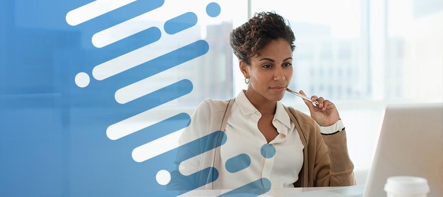 AHA Vitality Index. A black female hospital administrator looks at a computer screen and reviews health insurer claims and payment data.